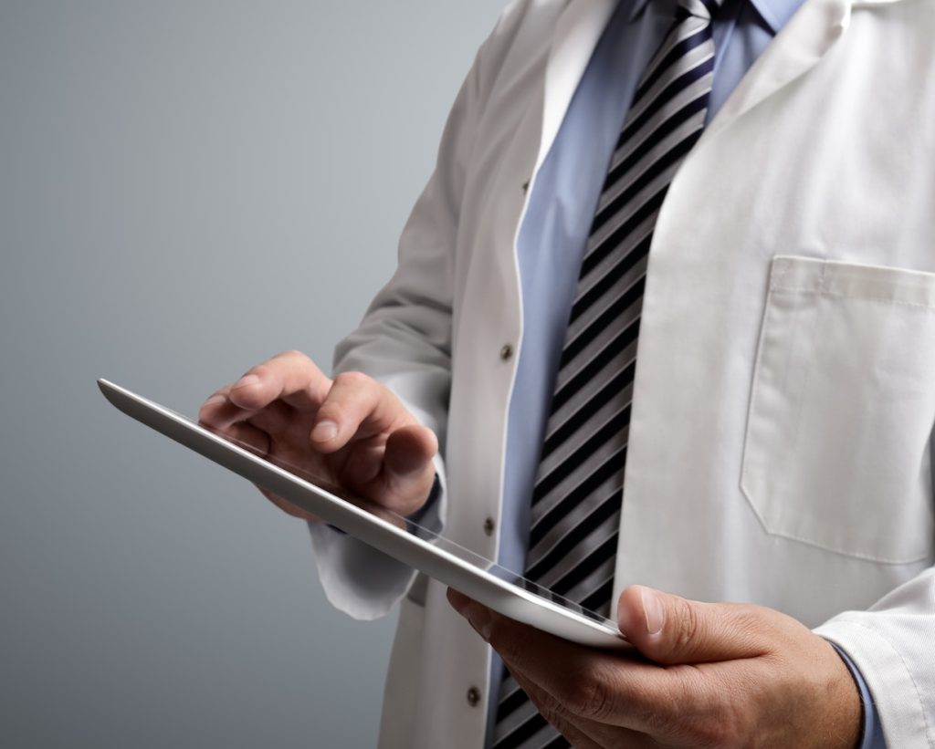 Doctor using digital tablet in healthcare facility