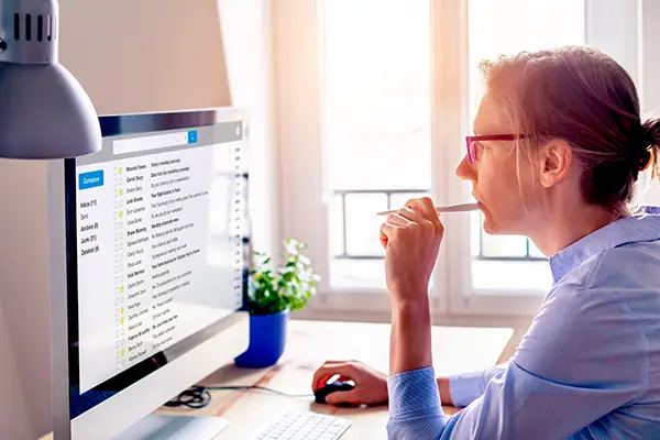 business woman looking at computer monitor and checking her email