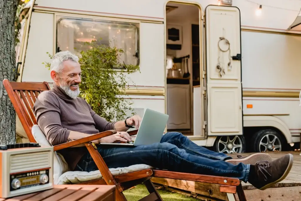 Retiree using laptop over Wi-Fi at an RV Park